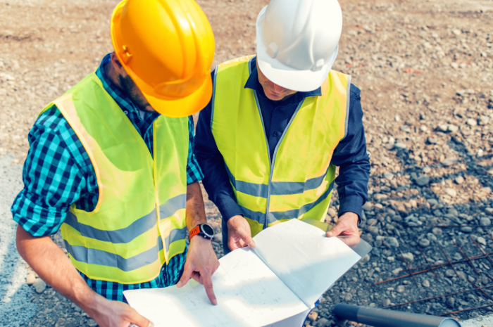 QBCC financial reporting due 31 March 2021 | DGL Accountants Mackay Tradesmen looking over plans on construction site